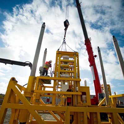 The world's largest Clamp connector is put together outside the Depro building using a crane truck.