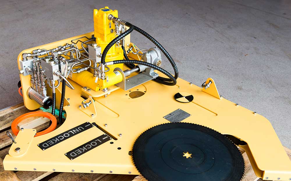 A cutting tool for pipelines and steel structures subsea laying on the floor in Depro's workshop hall.